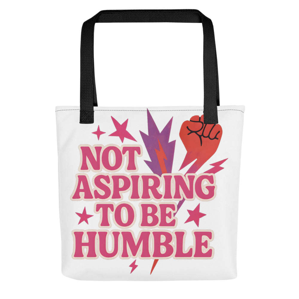 Typography with red raised fist and text 'Not Aspiring to Be Humble' Tote Bag front view — Wandering With Pride