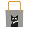 Black cat with a white bone around its neck Tote Bag front view — Wandering With Pride