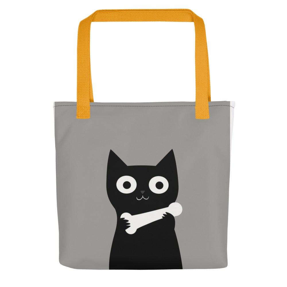 Black cat with a white bone around its neck Tote Bag front view — Wandering With Pride