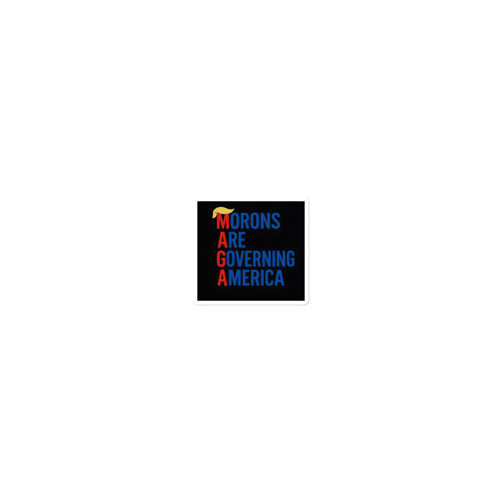 American flag with Trump hair 'M' and 'MORONS ARE GOVERNING AMERICA' text Sticker front view — Wandering With Pride