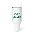 DEFY GRAVITY typography in blocky green letters on black Travel Mug front view — Wandering With Pride