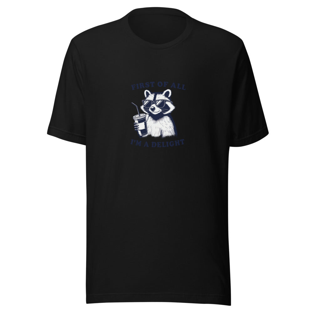 cartoon raccoon wearing sunglasses and holding a coffee cup with 'First of all, I'm a delight' typography Tee front view — Wandering With Pride