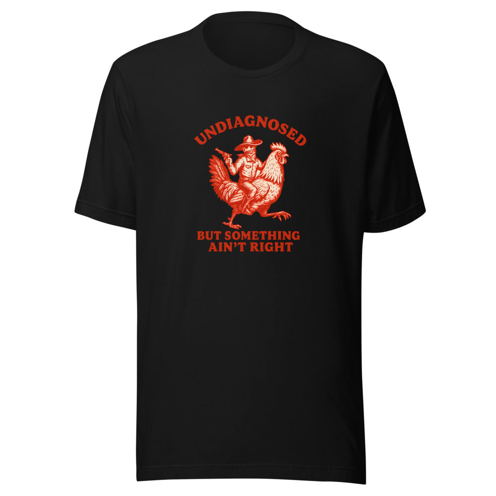 Cartoon chicken in cowboy hat with gun and text 'Undiagnosed' / 'But Something Aint Right' Tee front view — Wandering With Pride