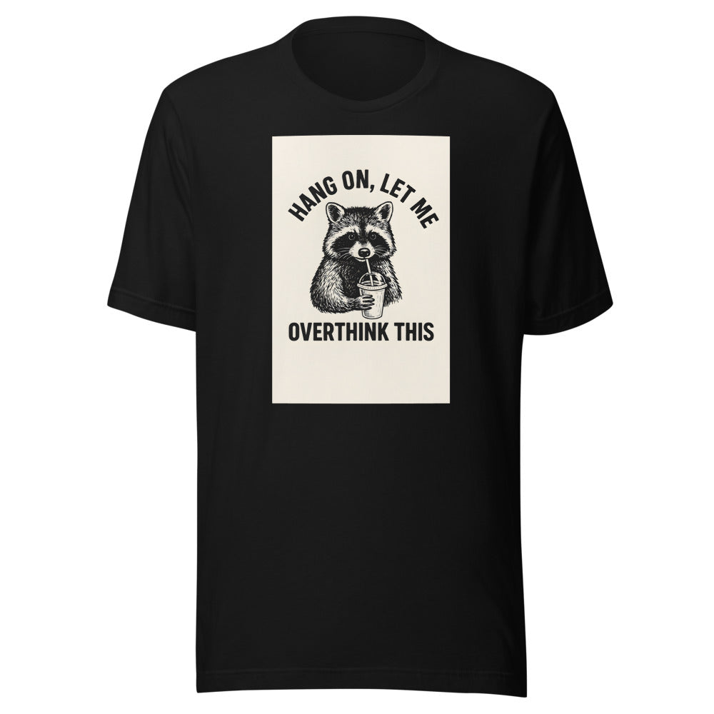 cartoon raccoon holding coffee with straw, surrounded by text 'HANG ON, LET ME OVERTHINK THIS' Tee front view — Wandering With Pride